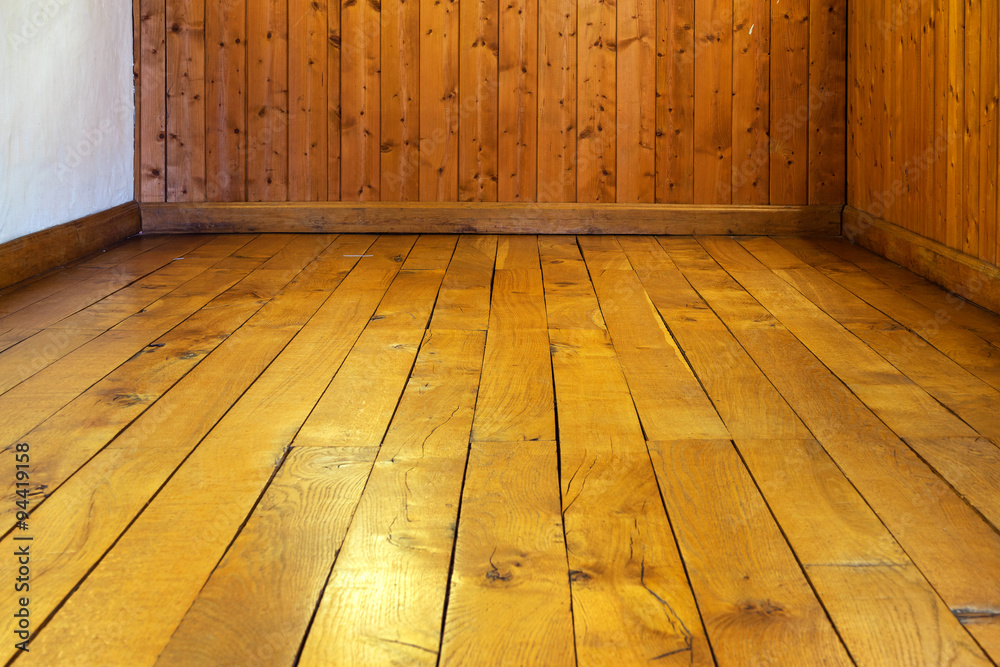 Old varnished wooden floor and wall of  room - obrazy, fototapety, plakaty 