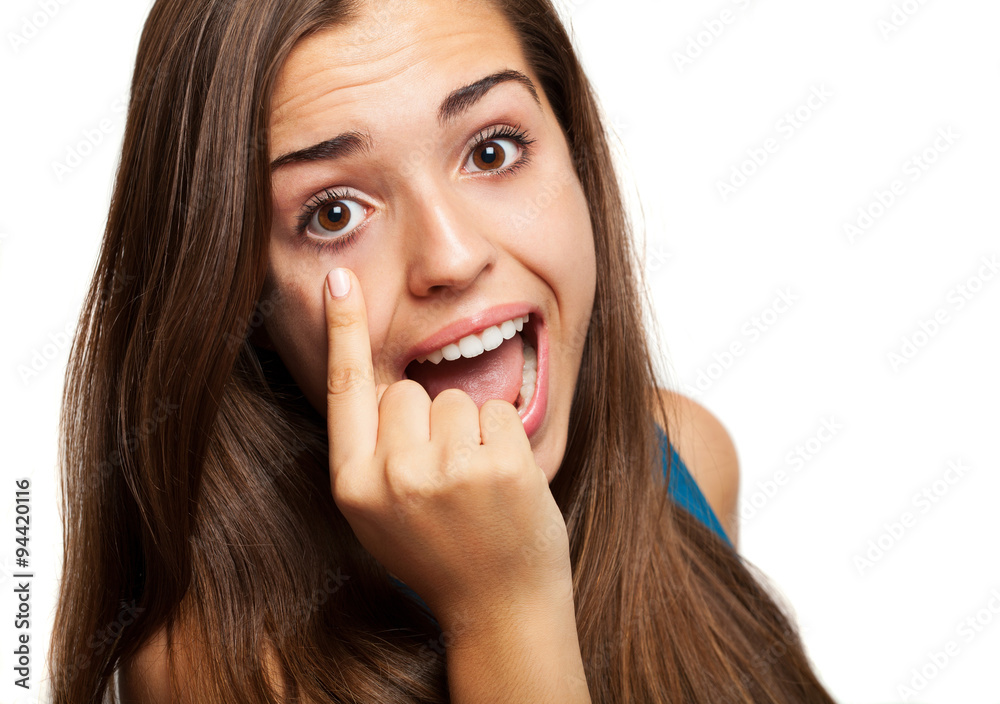 young woman pointing her eye on white background young woman pointing her eye on white background