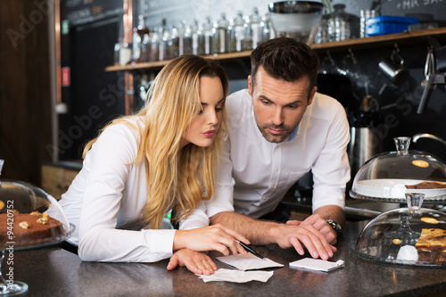 Small business owner calculating revenue