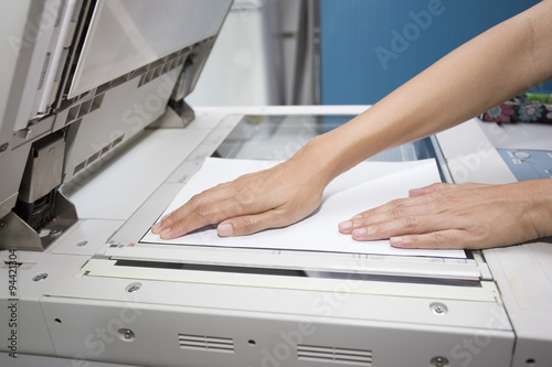 Canvastavla woman hands putting a sheet of paper into a copying device
