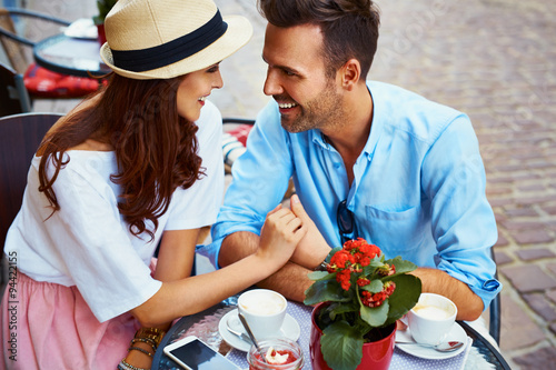 Couple in love sitting in cafe looking at each other