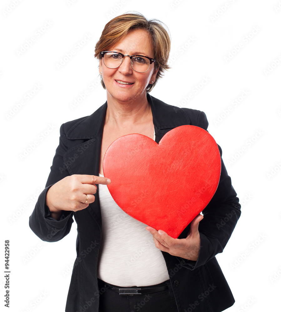 portrait of a mature business woman holding a heart portrait of a mature business woman holding a heart