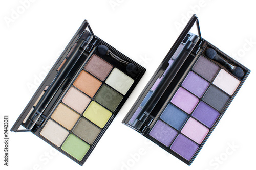 green and purple tone eye shadows makeup kit on white background