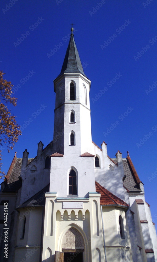 White church with tower above the entrance