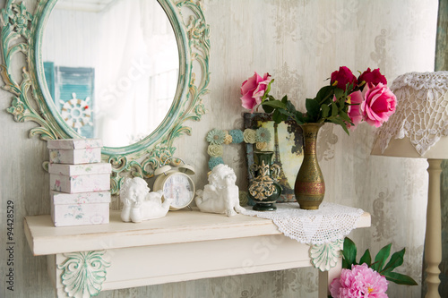 Closeup vintage interior with mirror and a table with a vase and