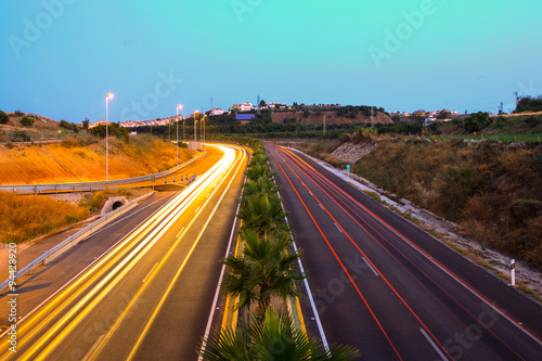 Experience the mesmerizing night traffic on Autovia del Sol in Andalusia,Spain,as the bustling lights and bustling cars create a captivating spectacle.