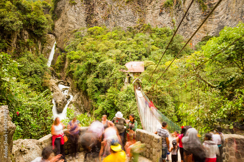 Experience the awe inspiring Pailon del Diablo waterfall and its bustling observation balcony,attracting numerous tourists,captured beautifully through long exposure photography.