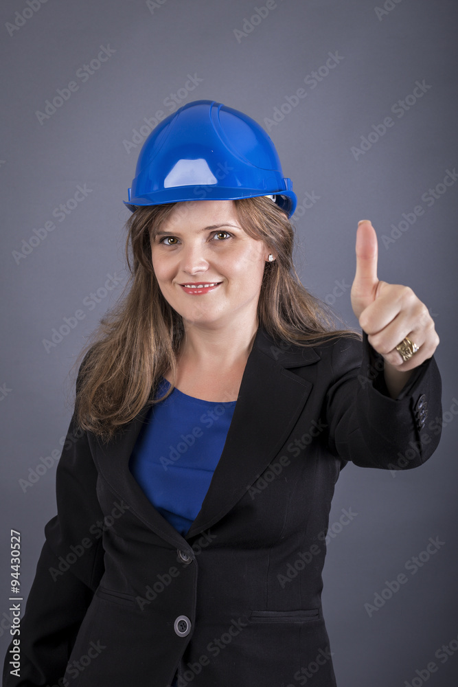 Happy young woman with hardhat showing ok sign Happy young woman with hardhat showing ok sign