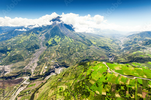 A breathtaking view of the Tungurahua volcano in Ecuador, surrounded by lush greenery and a stunning natural landscape.