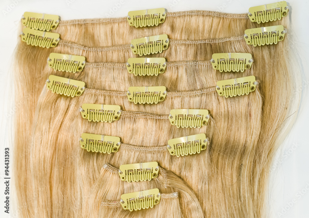 Blonde clip in hair extensions - stock image