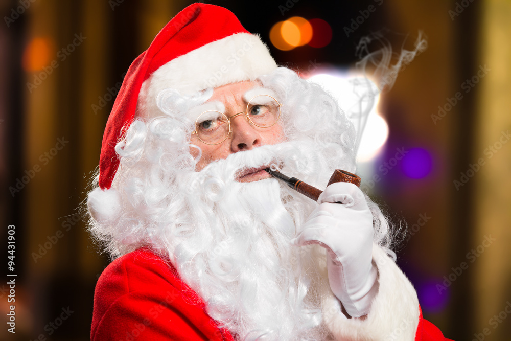 Santa Claus smoking a tobacco pipe Stock Photo | Adobe Stock