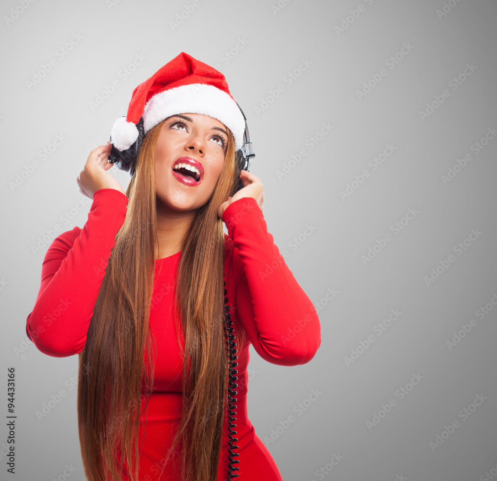 portrait of a beautiful young woman listening on headphones at Christmas
