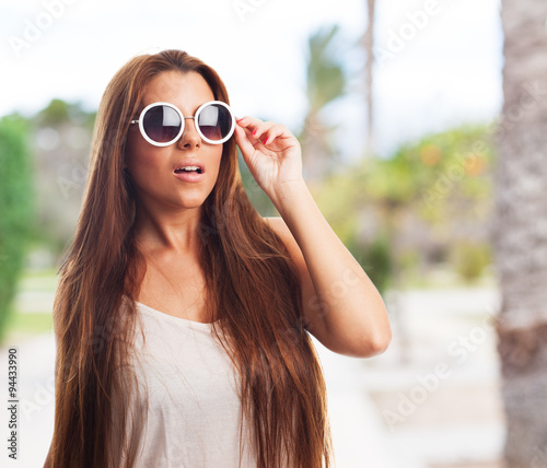 portrait of a young woman wearing a round sunglasses