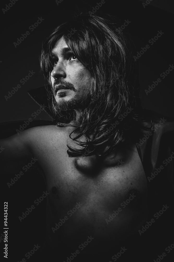 Face, vampire man with great contrasts of light, large black clo Face, vampire man with great contrasts of light, large black clo