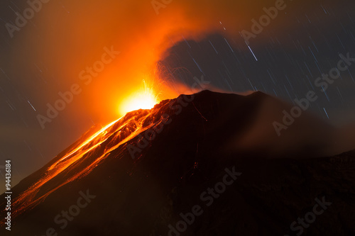A fiery eruption of Tungurahua volcano in Ecuador illuminates the night sky with a blazing flow of lava and magma.