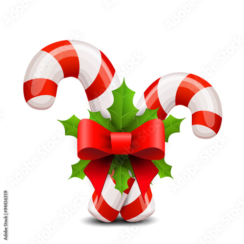 Christmas candy cane decorated with a bow and holly