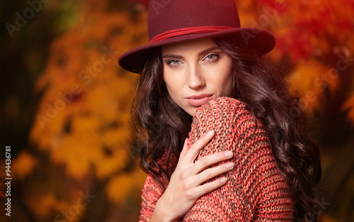 Beautiful elegant woman standing in a park in autumn © ZoomTeam