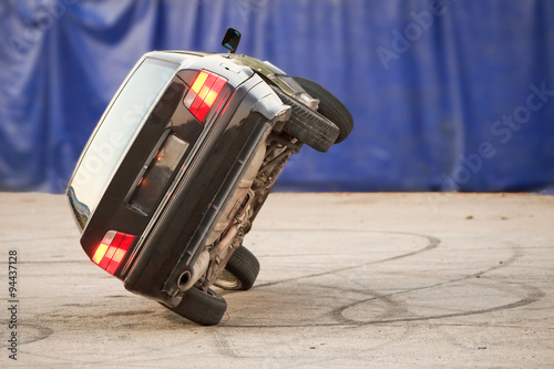 Photography A car performing a dangerous stunt with two wheels in motion, showcasing a thrilling rollover demo and the adrenaline-fueled art of driving