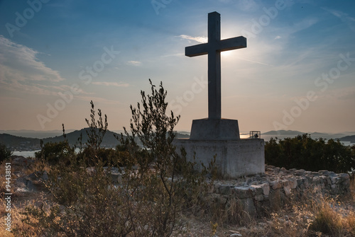 Cross against blue sky on sunny, summer day in Croatia
