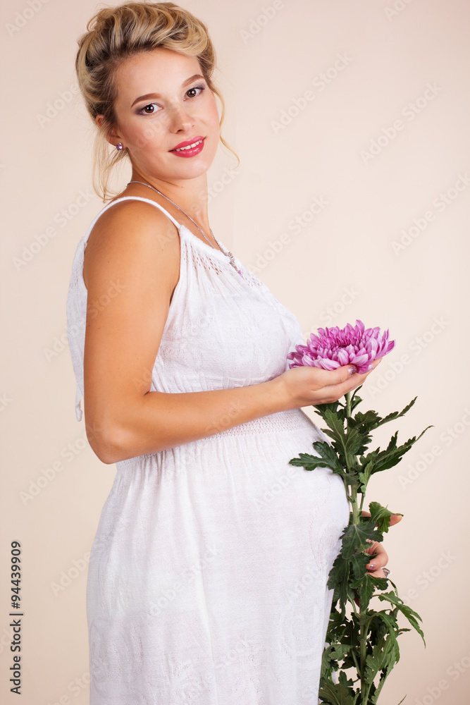 Pregnant woman with pink golden-daisy flower Pregnant woman with pink golden-daisy flower