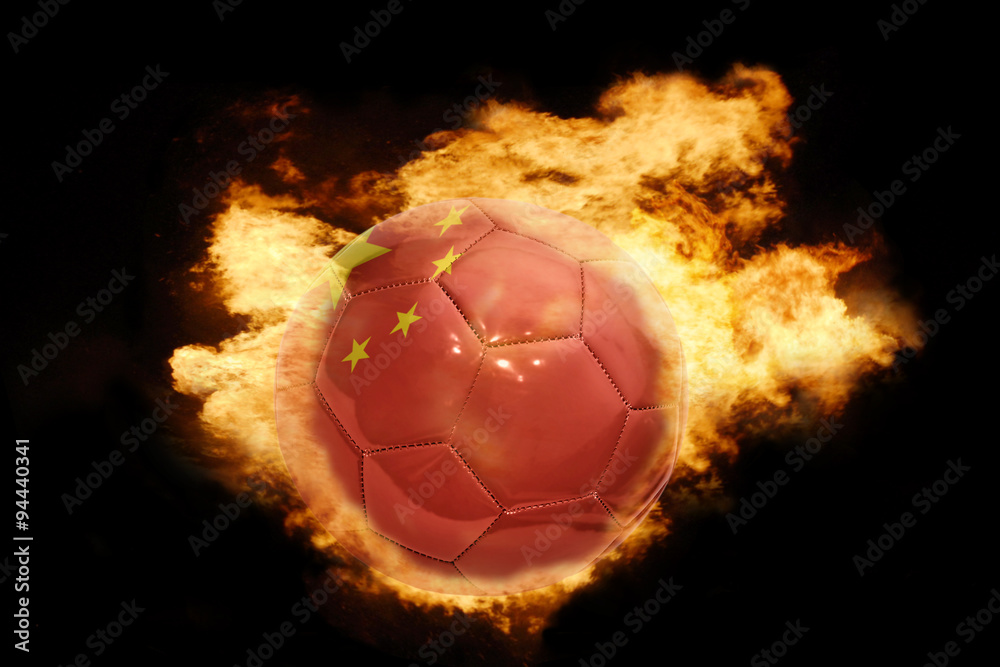 Naklejka premium football ball with the flag of china on fire