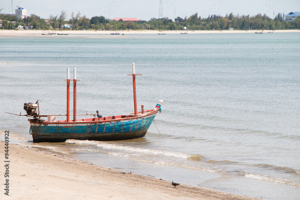 Fototapeta premium Fishing boat on the sea with sand in Thailand