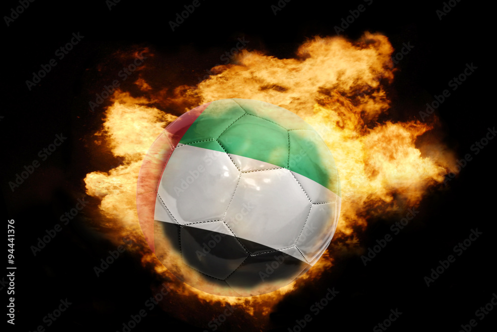 Fototapeta premium football ball with the flag of united arab emirates on fire