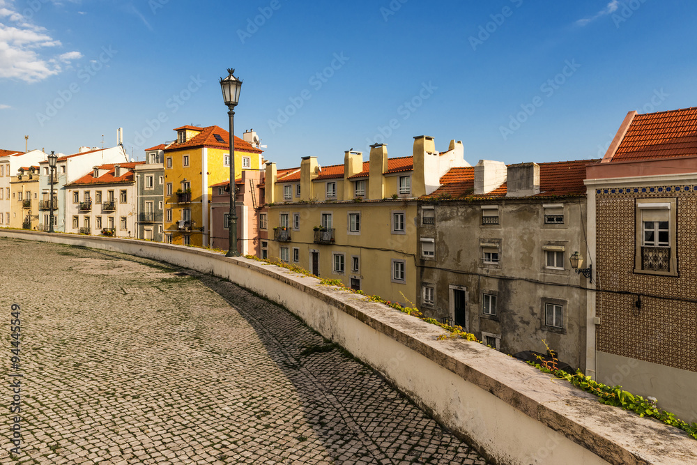 Street in Alfama, Lisbon, with old cobblestone and tiles