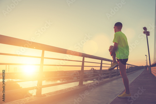 Urban jogger on a bridge.