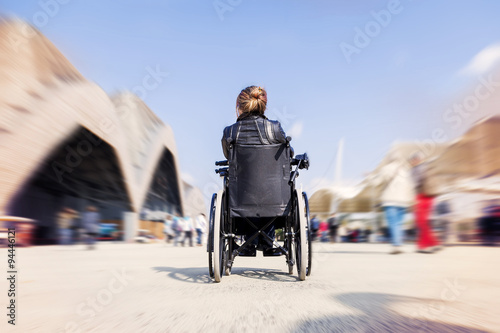 young lady in a wheelchair looking for a destination photo