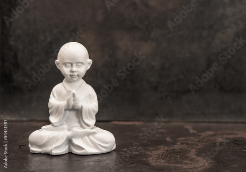 Praying buddha. White statue. Meditation concept