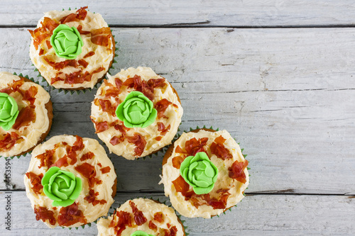 cup cakes cabbage and bacon shot from above on white wooden boards landscape