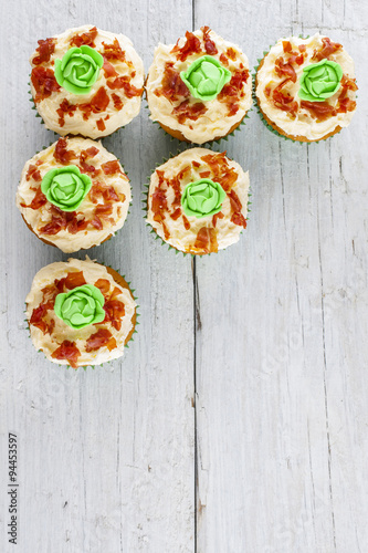 cup cakes cabbage and bacon shot from above on white wooden boards portrait