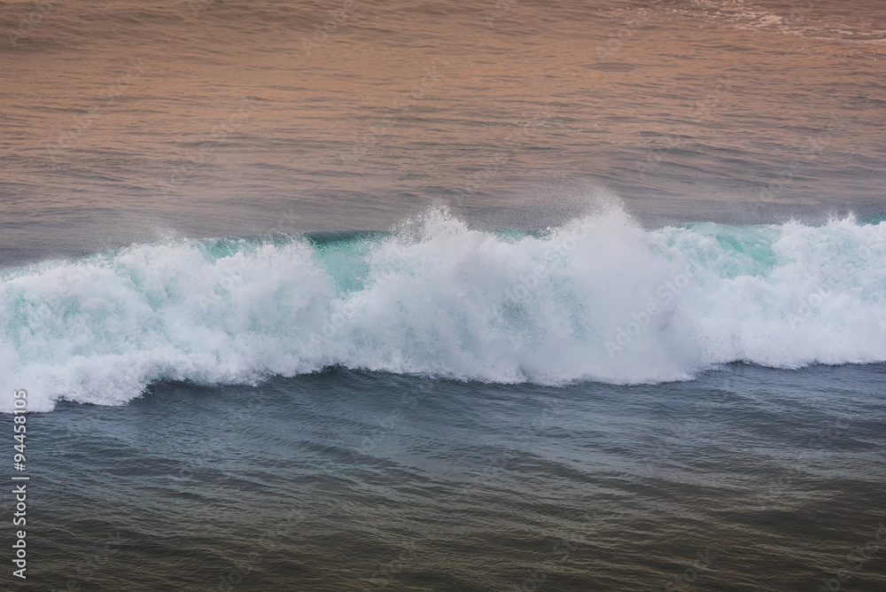 Blue wave at sunset Bali Beach ,Indonesia.