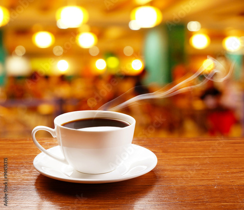 Wallpaper Mural Cup of coffee on table on bright background Torontodigital.ca