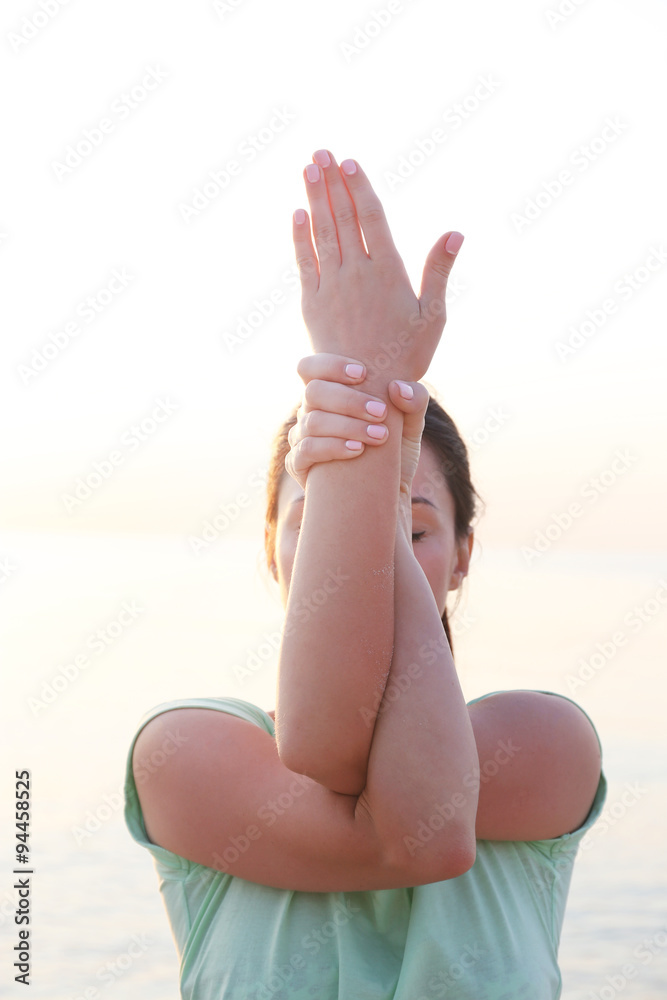 Close up portrait of woman doing yoga on sky background