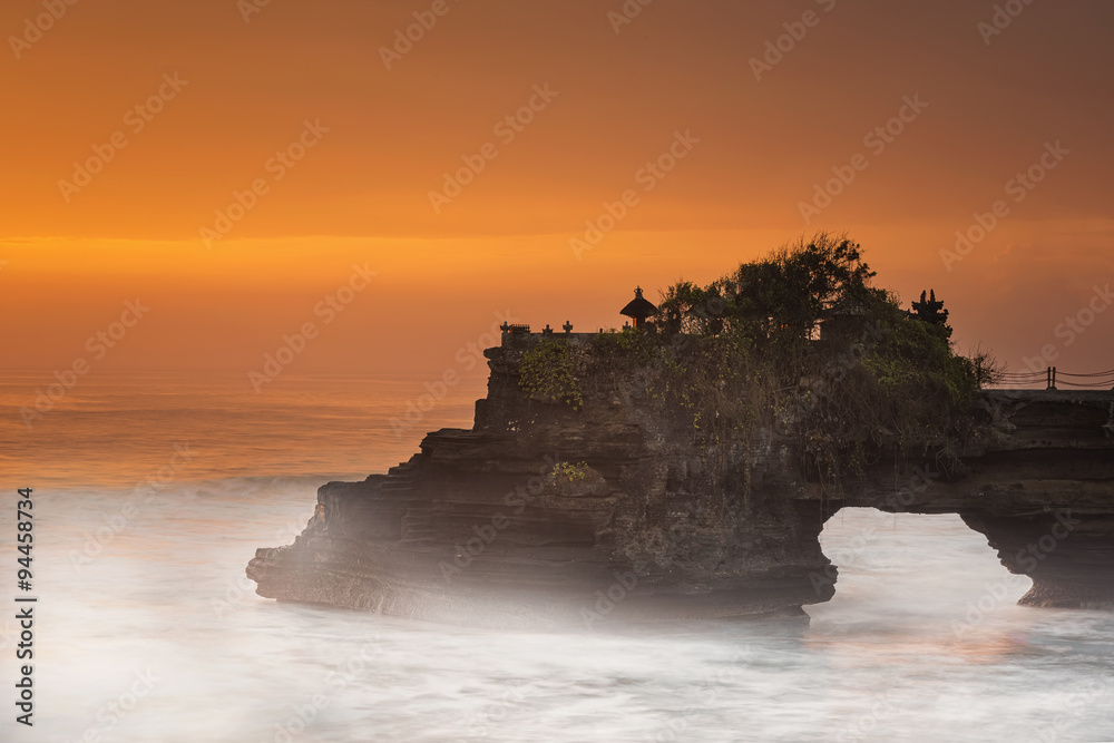Long exposure of Hindu temple Pura Tanah Lot and sunset Bali, Indonesia.
