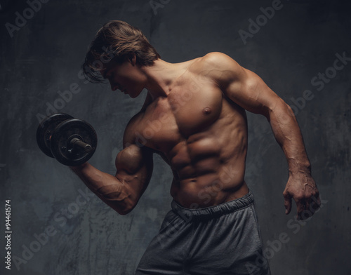 Shirtless bodybuilder doing exercises.