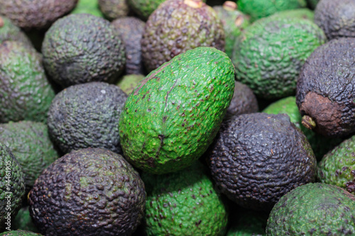Avocado background. Fresh green avocado on a market
