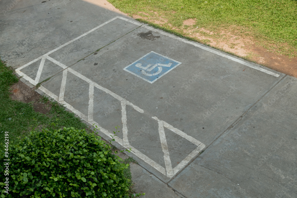 Fototapeta premium parking space reserved handicapped on road with disabled sign