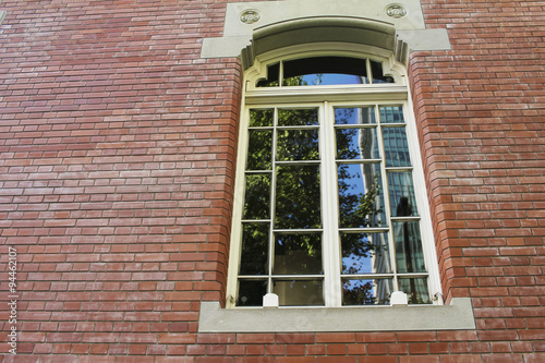 Scenery reflected in the windows on the building's brick photo