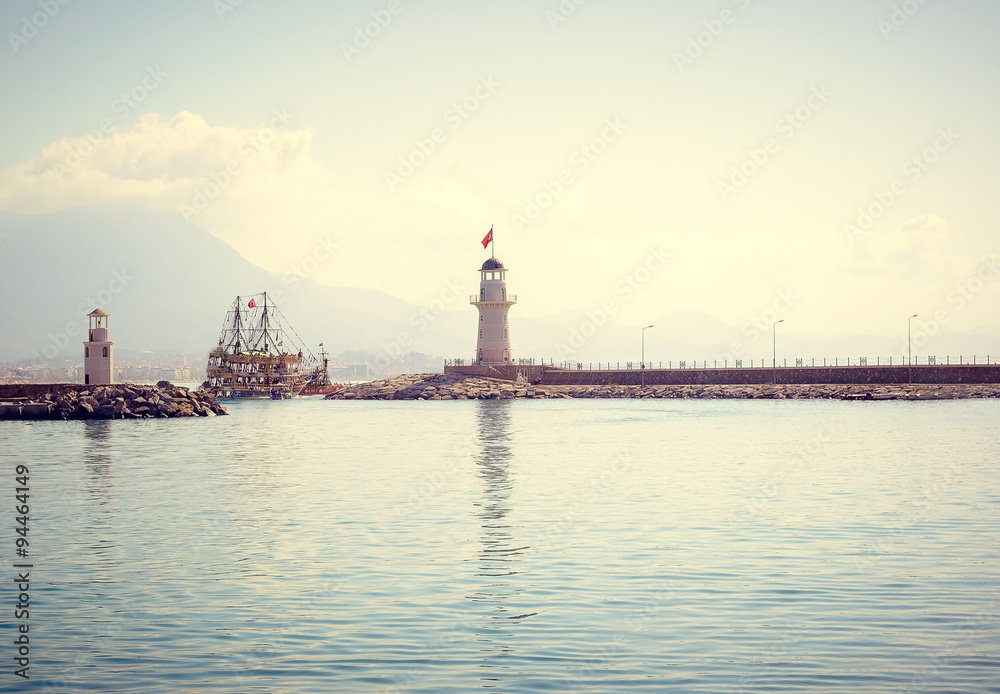Lighthouse and sail ships in the Mediterranean sea