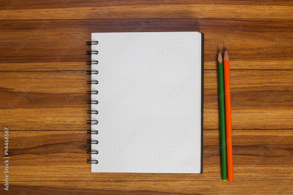 Notebook and pencil on the wooden floor. Notebook and pencil on the wooden floor.