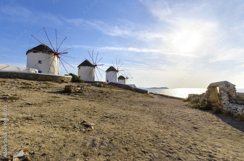 Five windmills in Chora,Mykonos,Greece.Traditional greek whitewashed architecture,a popular landmark,tourist destination on the island of winds,deep blue sky,Aegean sea. Wind mills are now decorative.