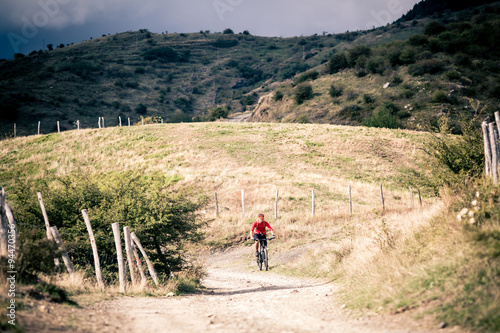Mountain bike MTB rider on country road, track trail in inspirat