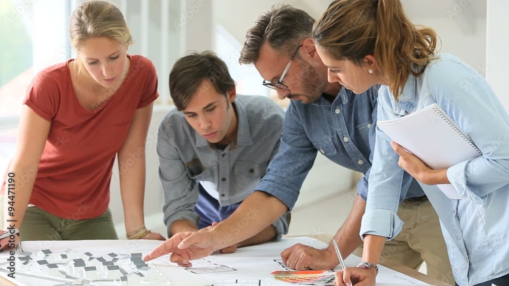 Students in architecture working on project with teacher