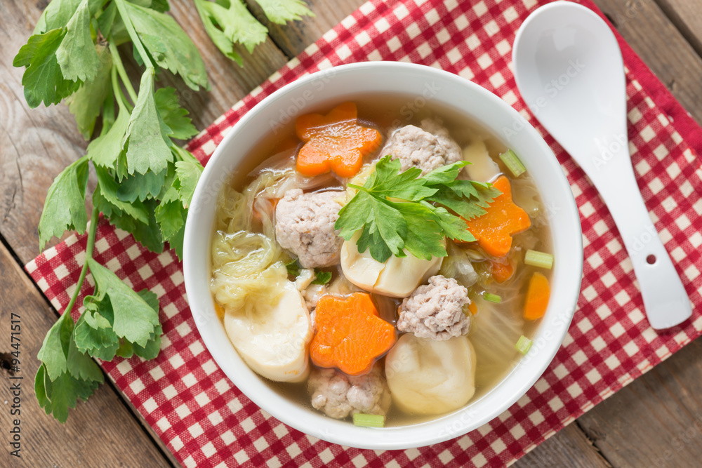 Clear Soup with Vegetables and Meatballs. Top view. Clear Soup with Vegetables and Meatballs. Top view.