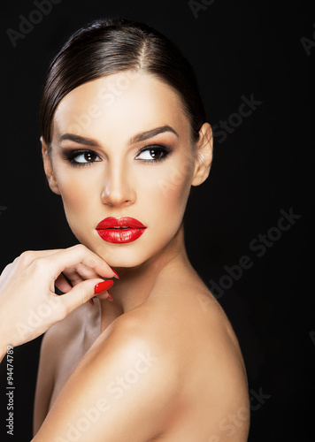 Beautiful woman portrait, beauty on dark background, red nails