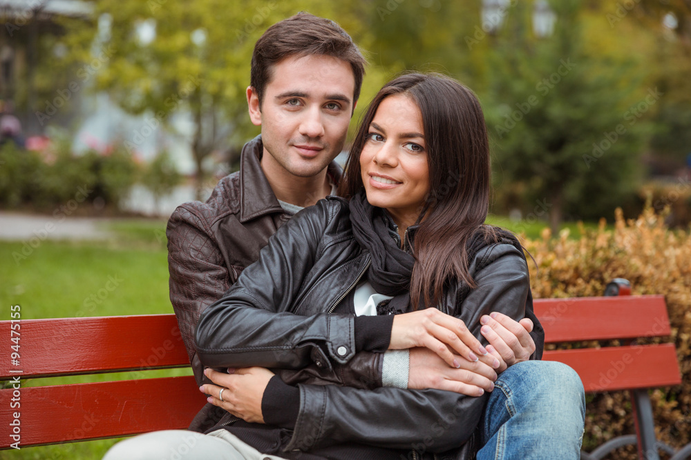 Couple sitting on the bench outdoors
