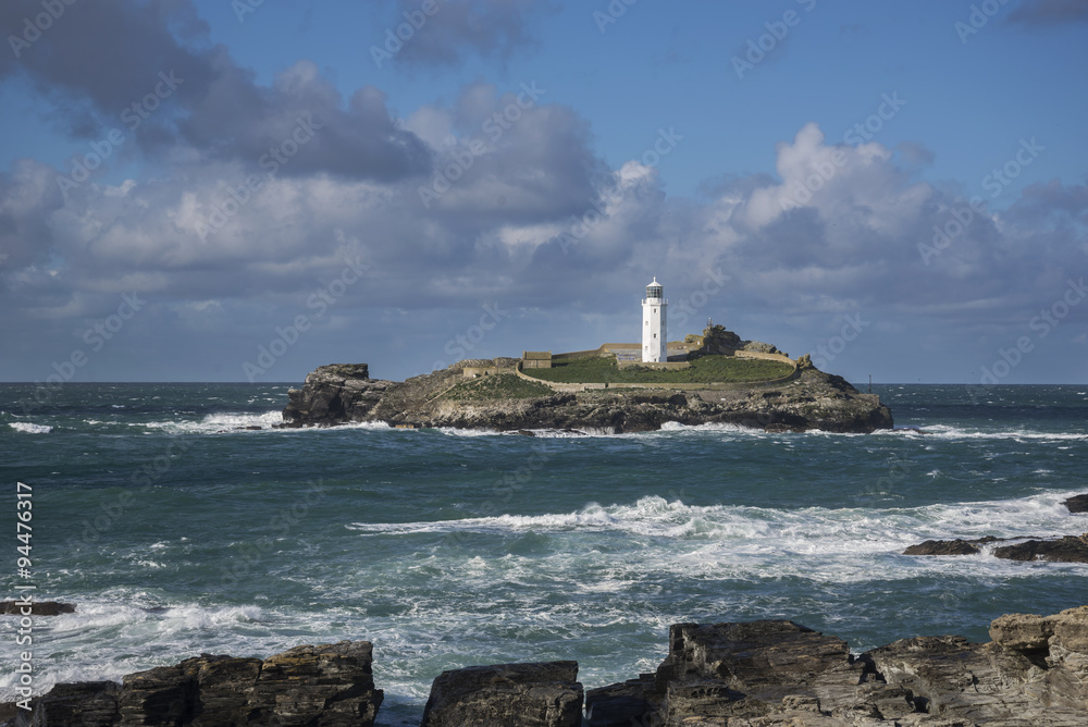 Godrevy lighthouse with waves on rocks